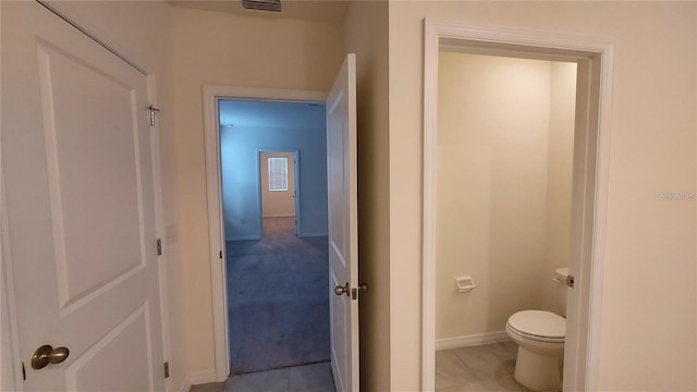 bathroom with baseboards, visible vents, and toilet