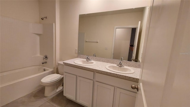 full bathroom with double vanity, a sink, toilet, and tile patterned floors