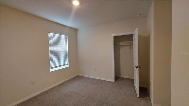 unfurnished bedroom featuring a closet, carpet, and baseboards