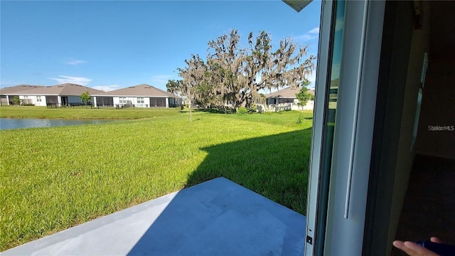 view of yard with a water view and a residential view