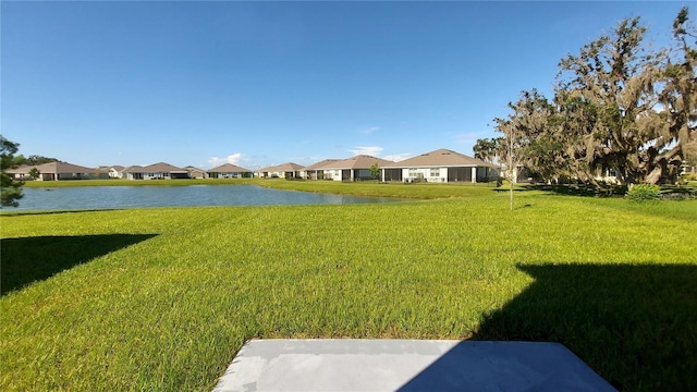 view of yard featuring a water view and a residential view