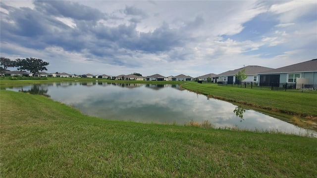 water view featuring a residential view and fence