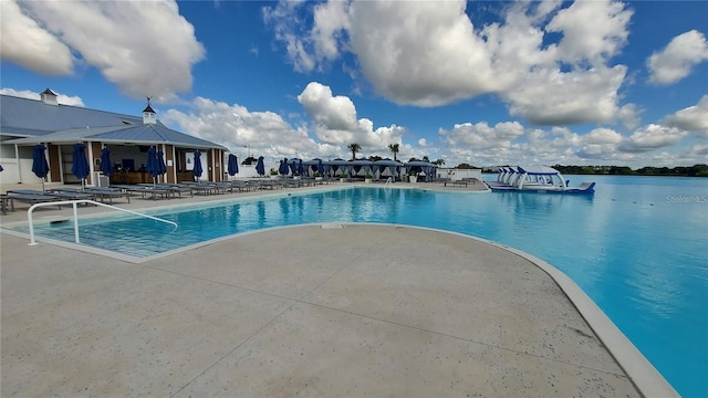 pool with a patio area and a gazebo