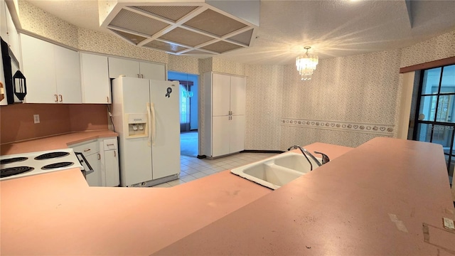 kitchen with white fridge with ice dispenser, custom exhaust hood, a sink, and wallpapered walls