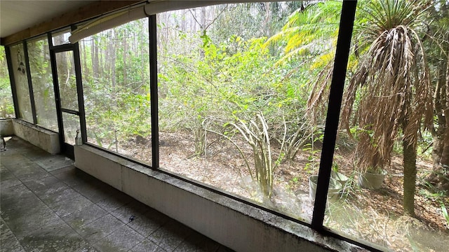 unfurnished sunroom with a view of trees