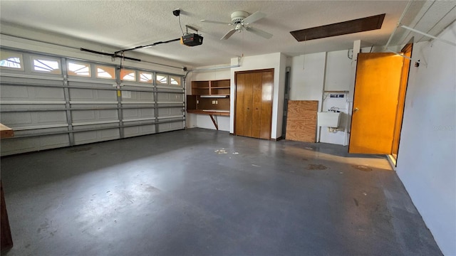 garage with a sink and a garage door opener