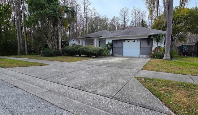 ranch-style house featuring driveway, an attached garage, a front lawn, and stucco siding