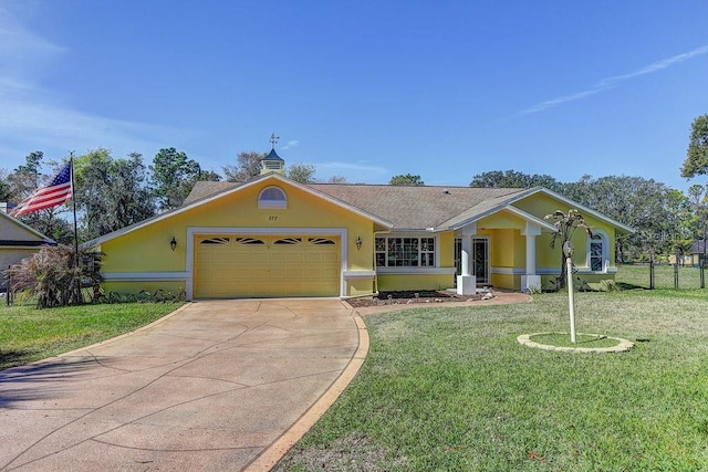 view of front of house featuring a garage, a front lawn, concrete driveway, and stucco siding