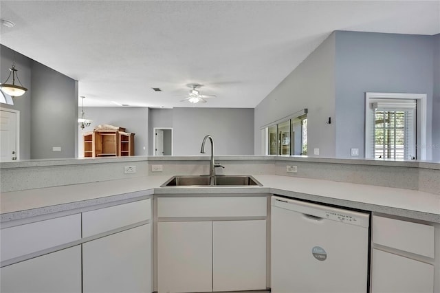 kitchen with light countertops, white dishwasher, and a sink