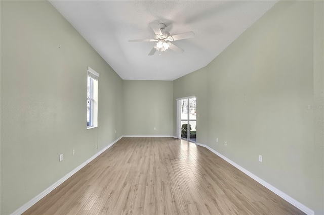 unfurnished room with ceiling fan, light wood-type flooring, and baseboards