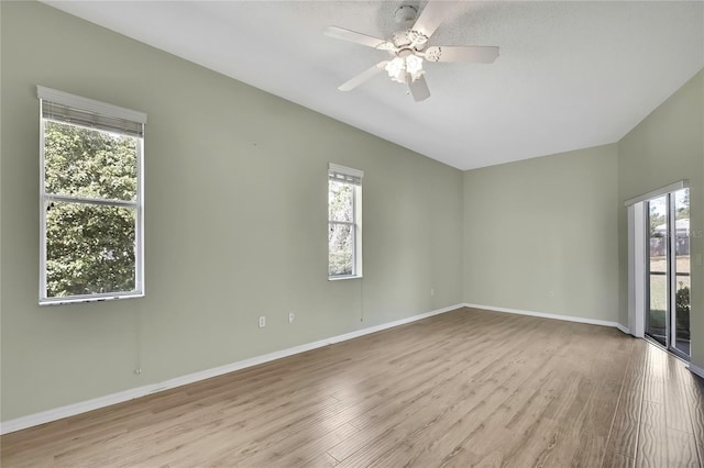 empty room featuring a ceiling fan, baseboards, and wood finished floors