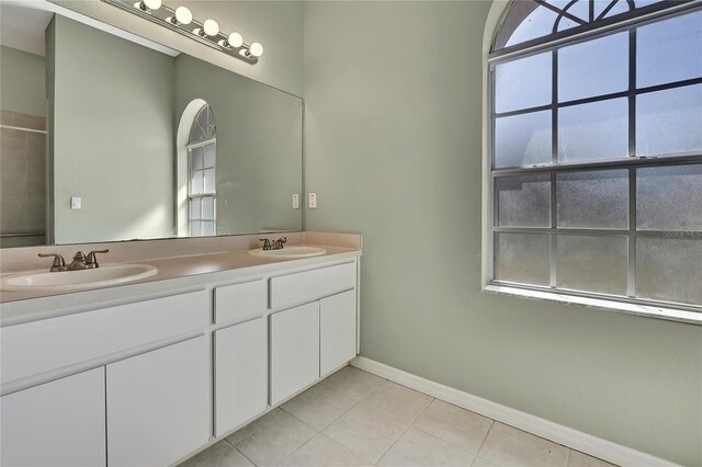 bathroom with a healthy amount of sunlight, a sink, and tile patterned floors