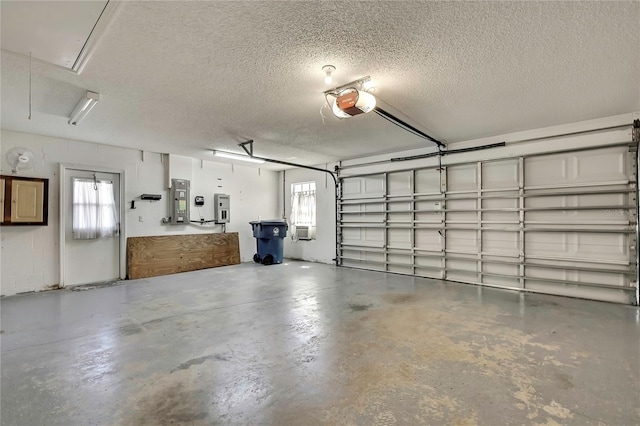 garage with electric panel and a garage door opener