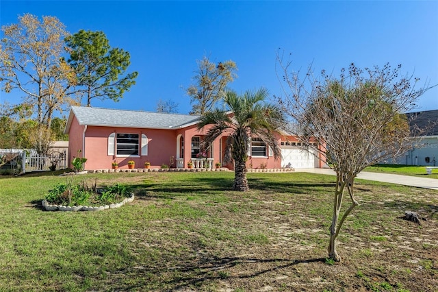 view of front of home with fence, stucco siding, concrete driveway, a front lawn, and a garage