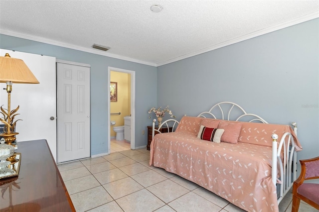 bedroom with visible vents, ensuite bath, light tile patterned flooring, ornamental molding, and a textured ceiling