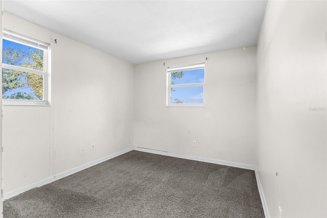 carpeted spare room with baseboards