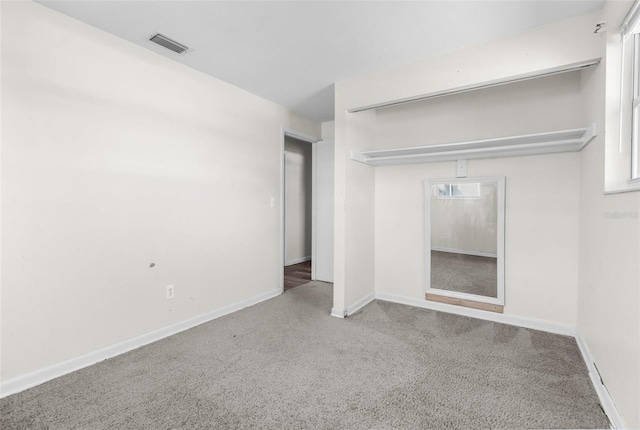 unfurnished bedroom featuring carpet, a closet, visible vents, and baseboards