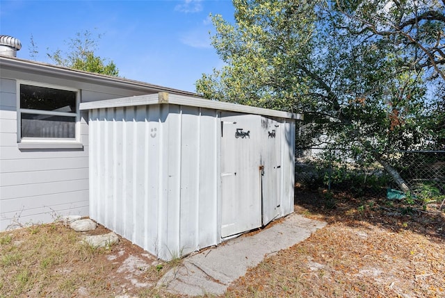 view of outbuilding with fence