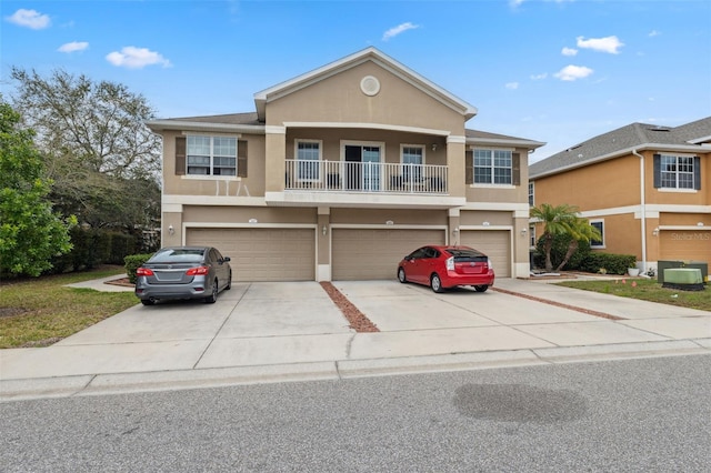 view of front facade featuring concrete driveway, a balcony, an attached garage, and stucco siding