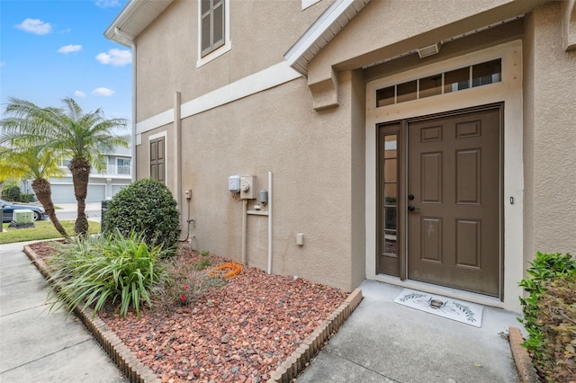 doorway to property with stucco siding