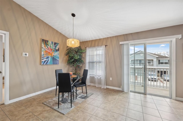 dining space featuring light tile patterned flooring, a healthy amount of sunlight, and baseboards