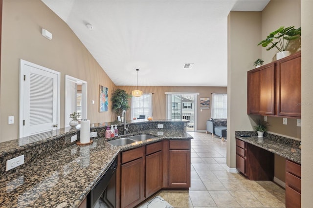 kitchen featuring dishwasher, lofted ceiling, a healthy amount of sunlight, and a sink