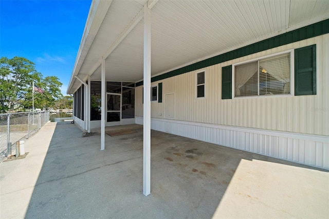 view of patio / terrace featuring an attached carport and fence