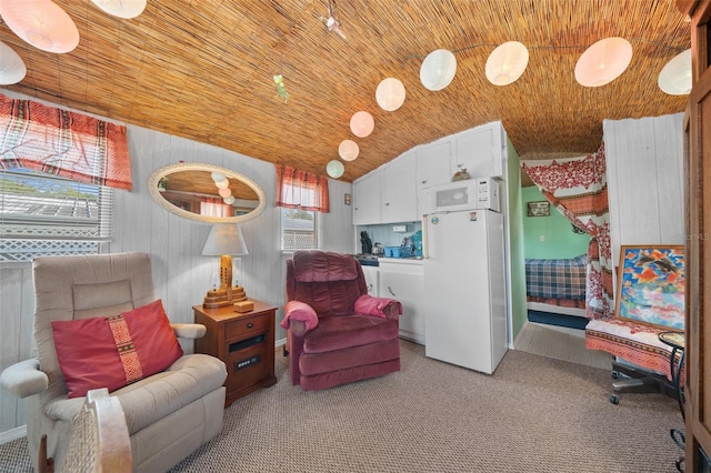 sitting room with carpet, vaulted ceiling, and wood ceiling