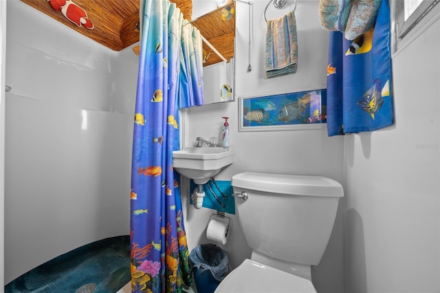 bathroom with curtained shower and toilet