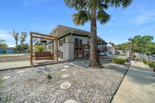 view of front of house with a patio and fence