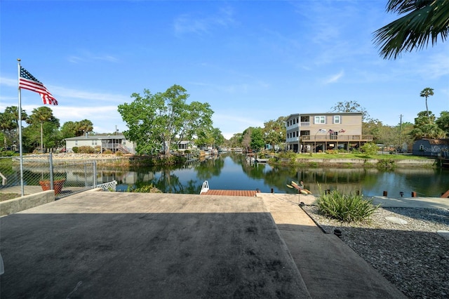 property view of water with a boat dock and fence