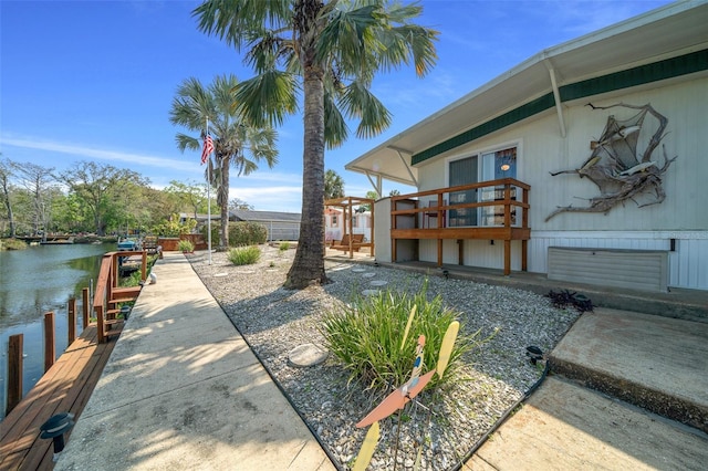 view of yard with a water view and a dock