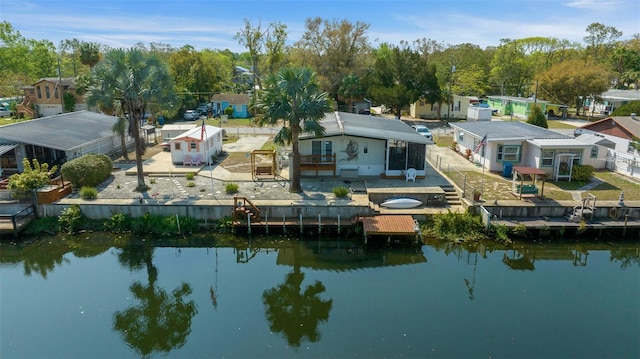 birds eye view of property with a water view and a residential view