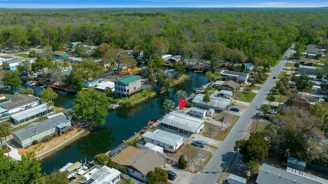 birds eye view of property with a view of trees, a water view, and a residential view