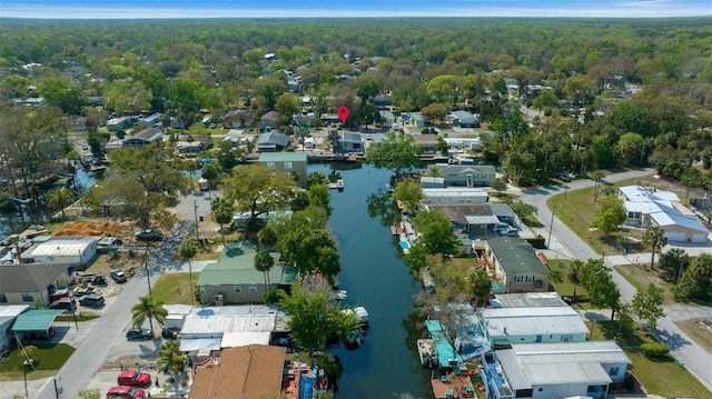 bird's eye view with a residential view, a wooded view, and a water view