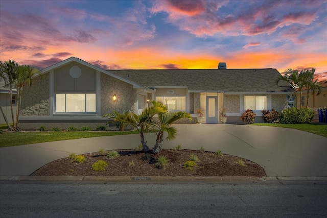 5000 Galleon Ct, New Port Richey, FL 34652 - view of front of property featuring curved driveway and stone siding