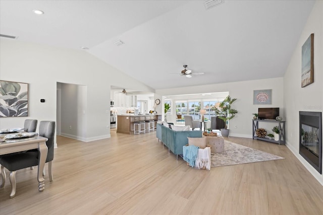 5000 Galleon Ct, New Port Richey, FL 34652 - living area with ceiling fan, vaulted ceiling, and light wood-style floors