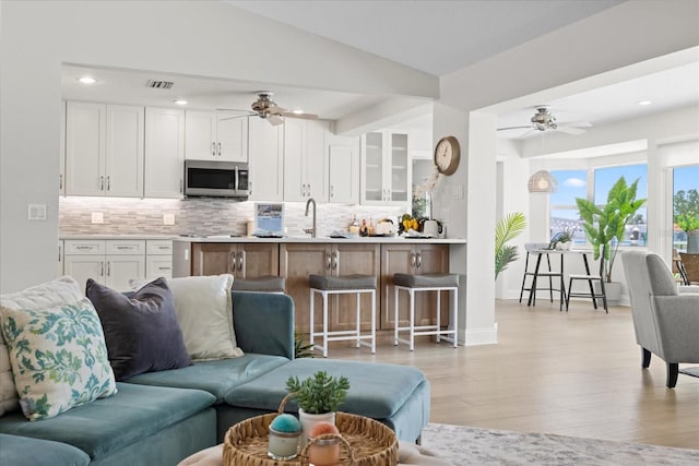 5000 Galleon Ct, New Port Richey, FL 34652 - living area with ceiling fan, light wood finished floors, and recessed lighting