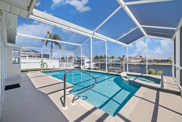 5000 Galleon Ct, New Port Richey, FL 34652 - view of pool featuring a patio area, a pool with connected hot tub, glass enclosure, boat lift, and a water view