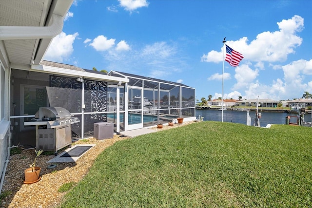 5000 Galleon Ct, New Port Richey, FL 34652 - view of grassy yard with a water view, an outdoor pool, and a lanai