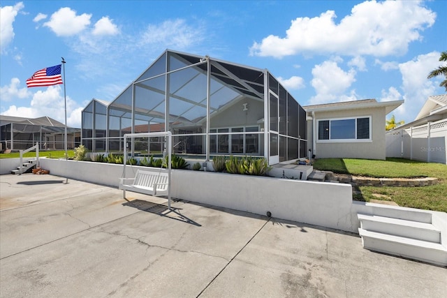 5000 Galleon Ct, New Port Richey, FL 34652 - rear view of property with a patio area, a lanai, and stucco siding