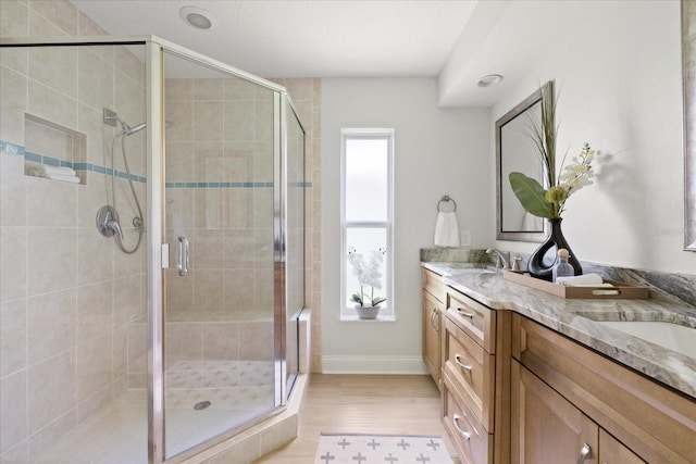 5000 Galleon Ct, New Port Richey, FL 34652 - full bath featuring double vanity, wood finished floors, and a shower stall
