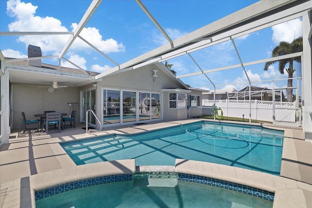 5000 Galleon Ct, New Port Richey, FL 34652 - view of swimming pool featuring a patio area, glass enclosure, a pool with connected hot tub, and outdoor dining space