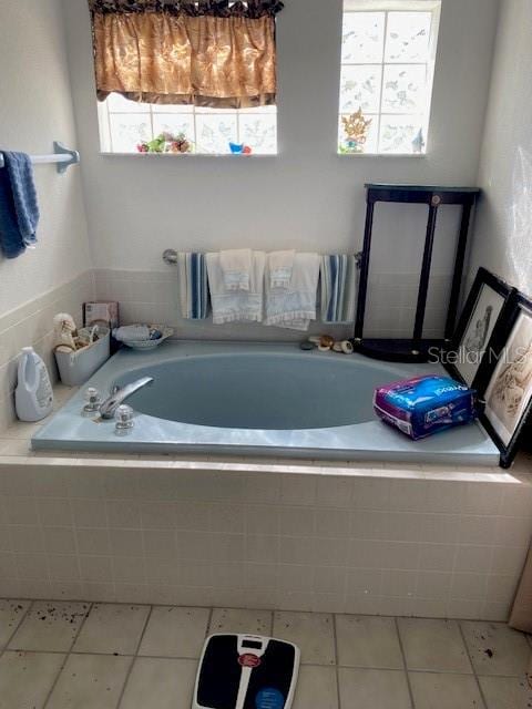 bathroom featuring a bath and tile patterned floors