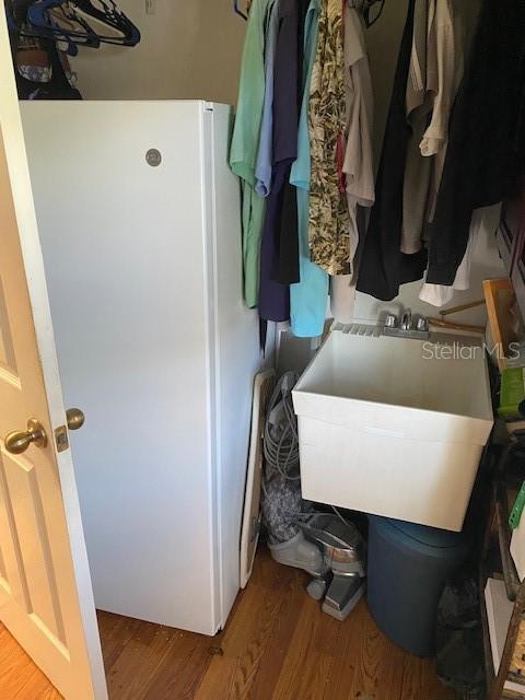 mudroom featuring a sink and wood finished floors