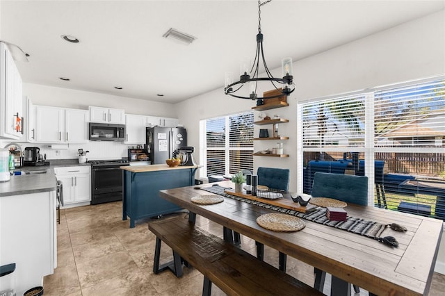 dining area with recessed lighting, visible vents, and an inviting chandelier