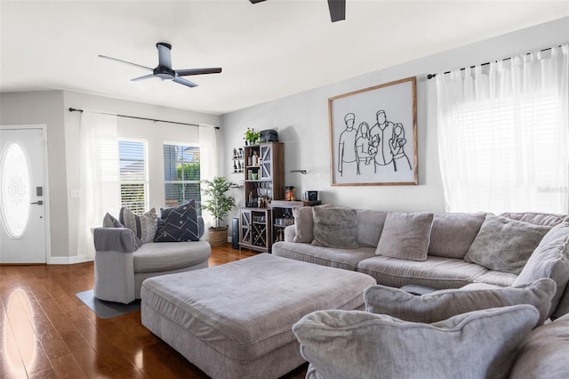 living area featuring hardwood / wood-style floors, baseboards, and ceiling fan