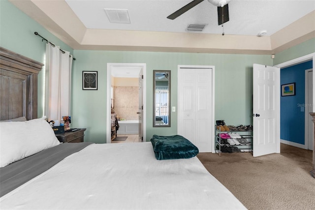 carpeted bedroom featuring visible vents, a closet, connected bathroom, and a ceiling fan