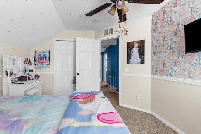 carpeted bedroom with visible vents, ceiling fan, baseboards, vaulted ceiling, and a closet