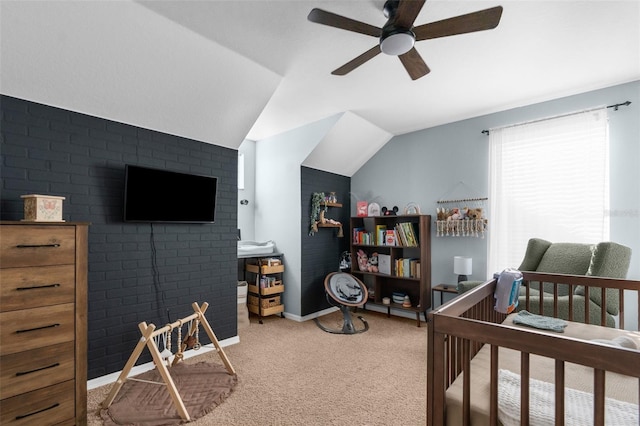 bedroom featuring brick wall, baseboards, vaulted ceiling, carpet flooring, and a ceiling fan